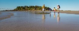 Family walking along Sandon River at low tide, Yuraygir National Park. Photo: OEH