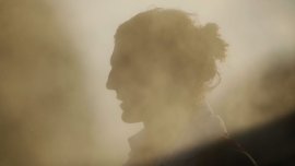 Kurt Tippett of the AFL team the Sydney Swans cools down in front of the misting fans to combat the heat during a game.